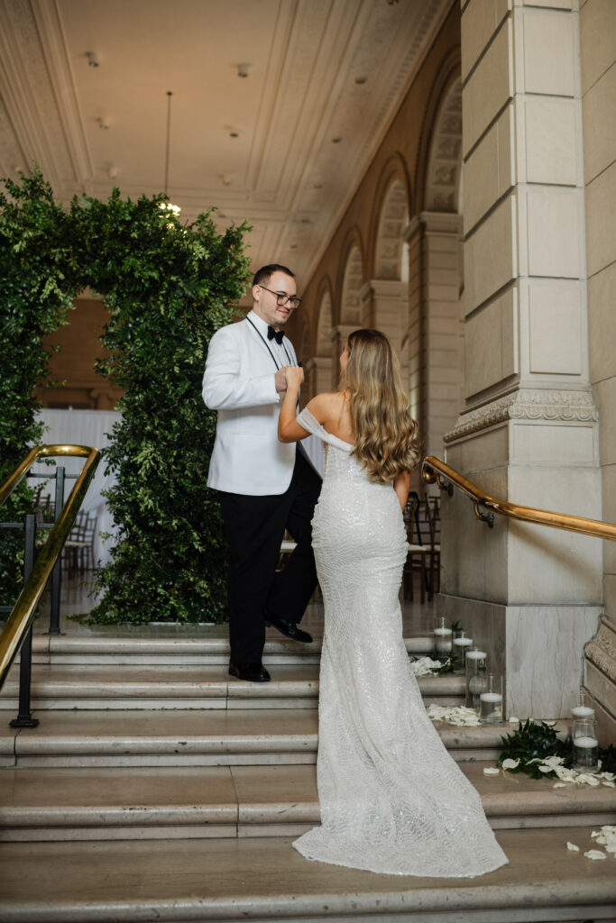 bride and groom on stairs inside the admiral room
