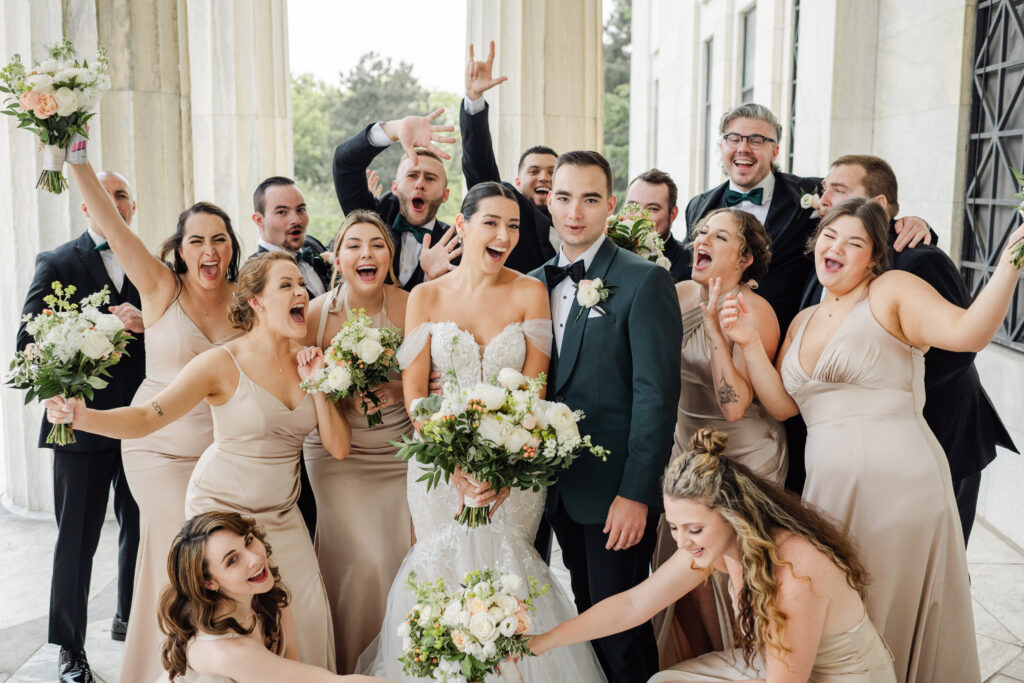 A group photo of the entire wedding party ready to celebrate their bride and groom.