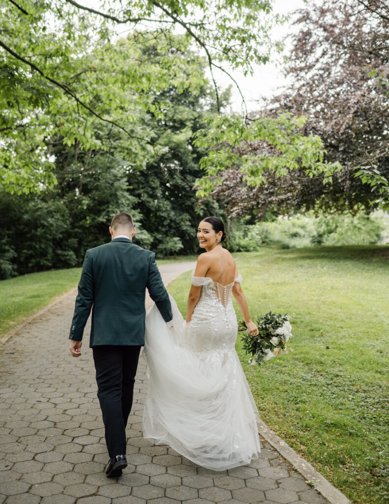 the bride and groom walking back to their limo bus after taking their wedding portraits.