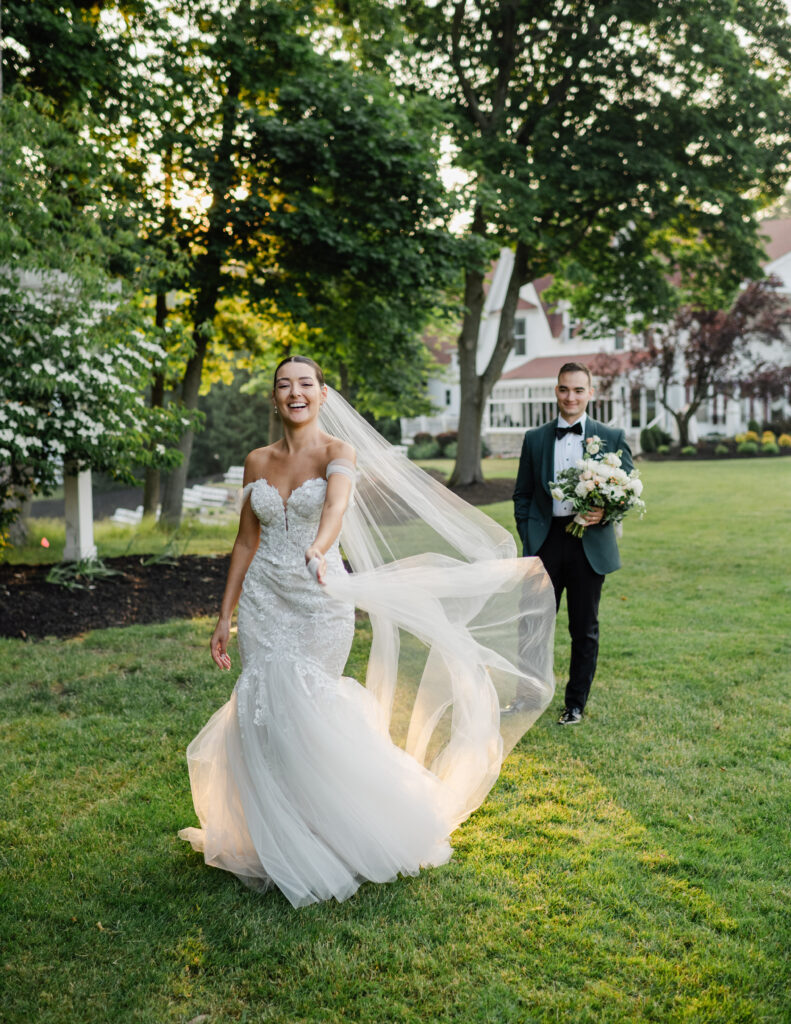 A bride and groom laughing during golden hour, captured candidly.