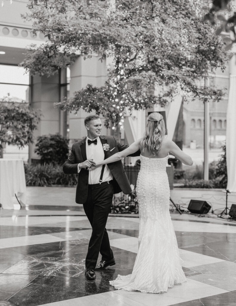 black and white image of bride and groom during their first dance at the wintergarden wedding venue in rochester ny