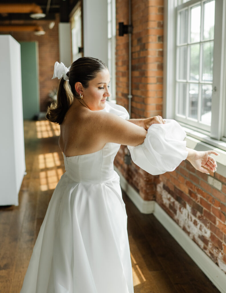 bride getting ready on her wedding day with puffy sleeved wedding dress