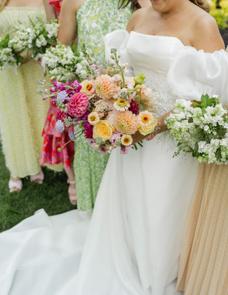 Puffy Sleeve Wedding Gown with Mismatched Bridesmaids Dresses and Wildroot Floral Bouquets