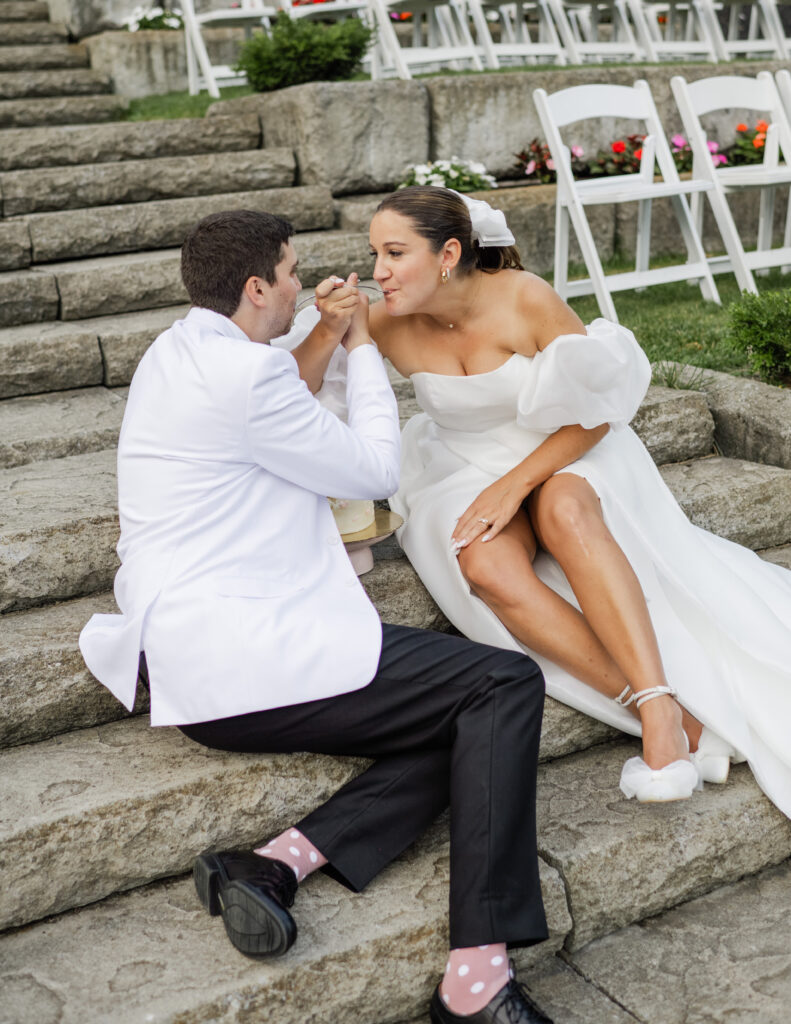 cake cutting privately on ceremony stairs between bride and groom