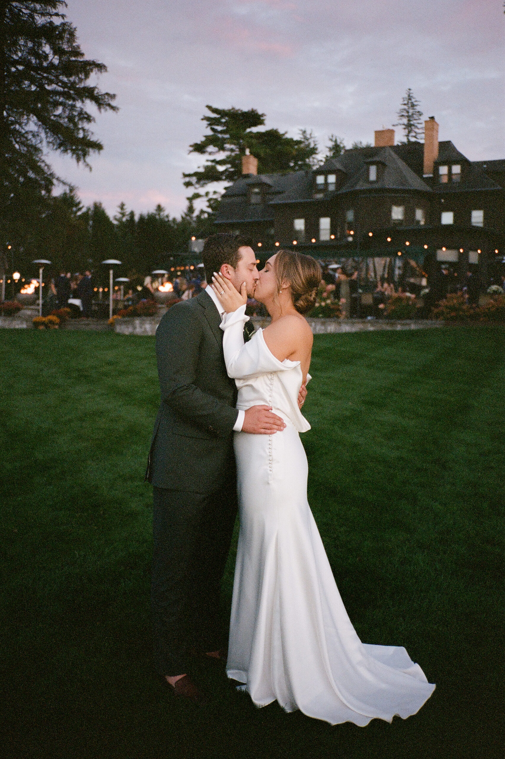 A wedding photo captured on 35mm film featuring a bride and groom with a timeless, grainy aesthetic.