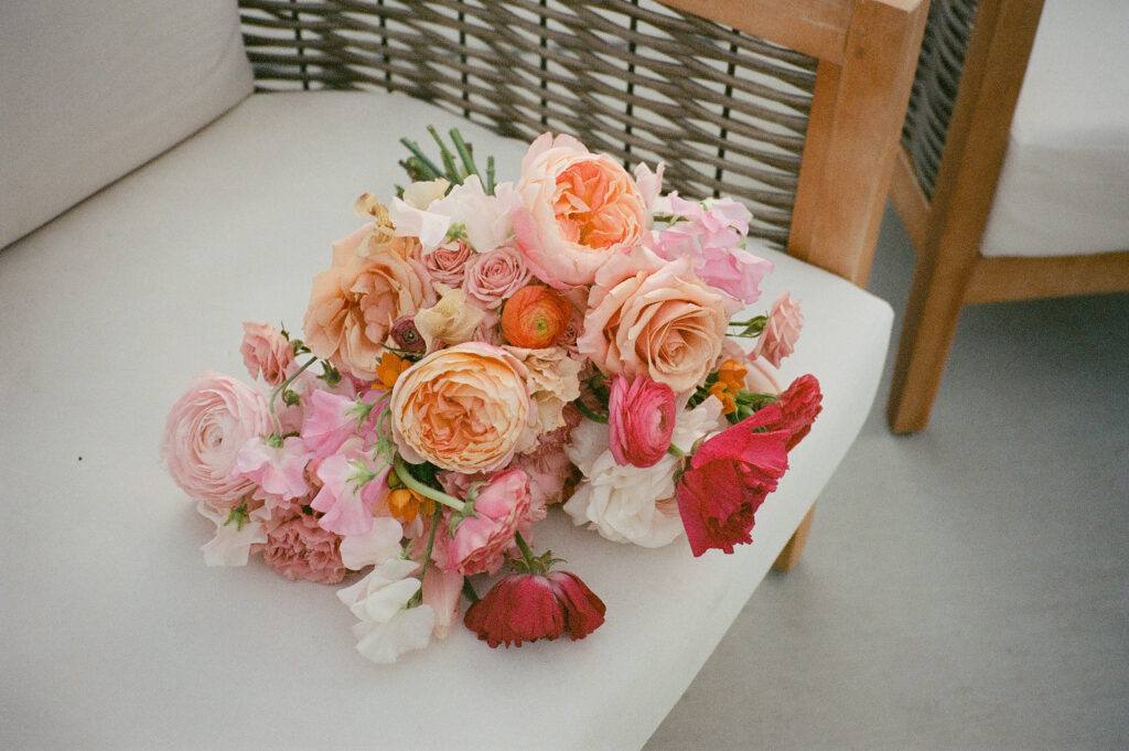 a 35mm film image of a bright pink and orange toned bouquet for a palm springs elopement