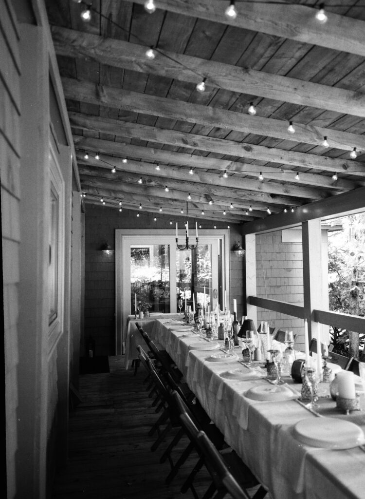 a black and white 120mm image of a micro wedding dinner tablescape