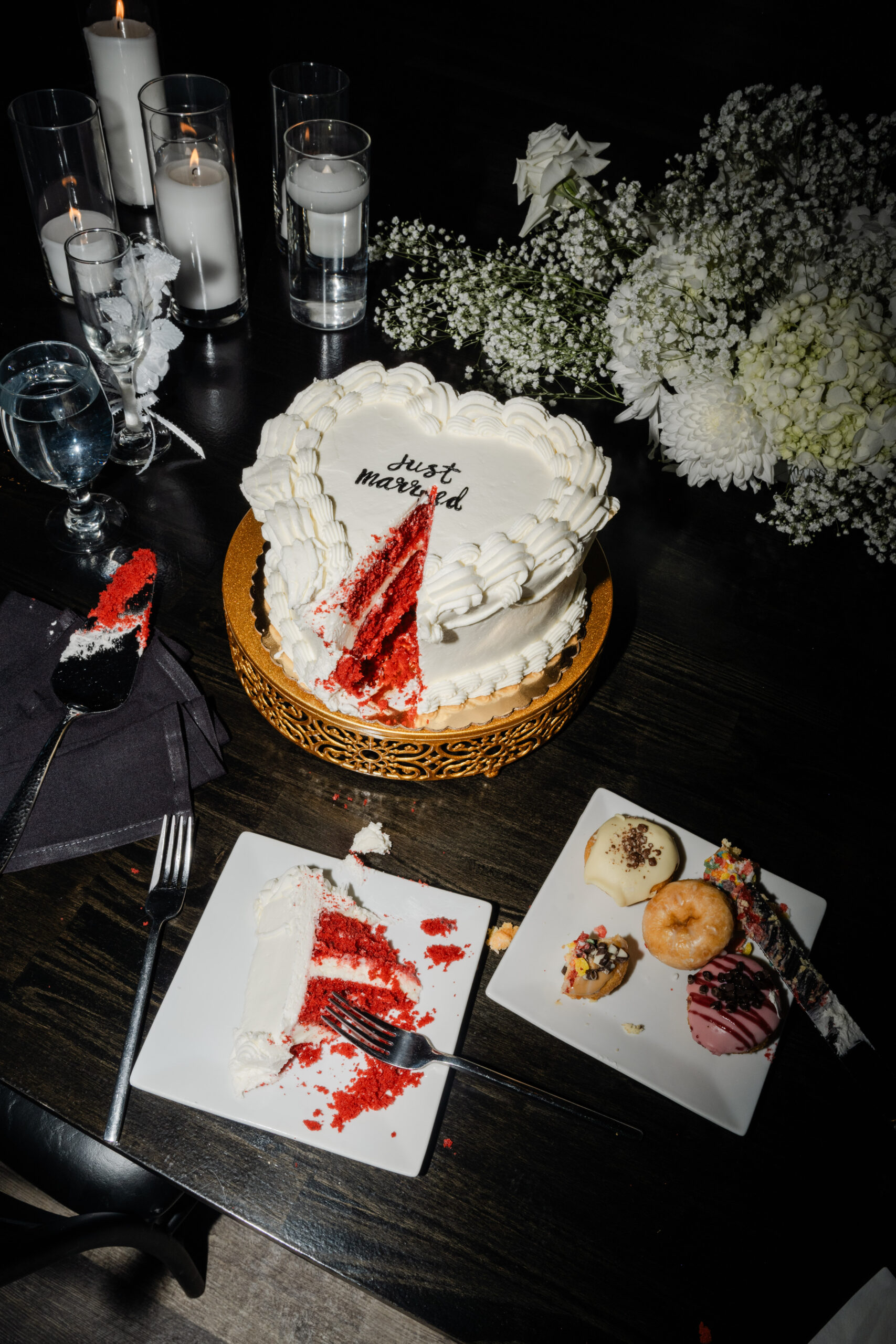 direct flash detail shot of cake cutting aftermath on a wedding day - unique wedding cake with red velvet inside