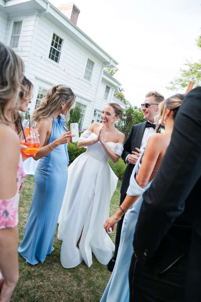 Black tie optional attire with groomsmen in The Black Tux and bridesmaids in mixed blue tones.