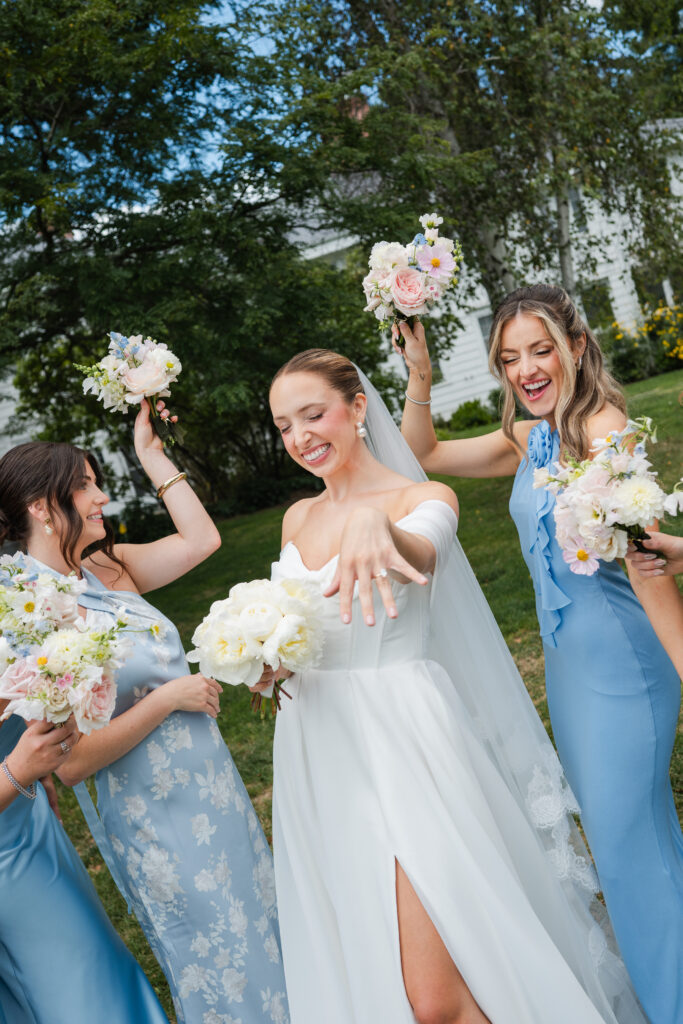 Blue bridesmaid dresses and floral bouquets by Tarry Grove at summer wedding in East Aurora