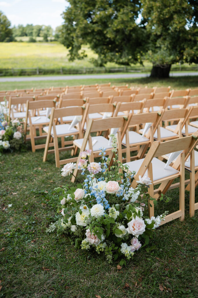 Garden party ceremony setup on the lawn of The Mansion at Knox Farm with floral gardens.