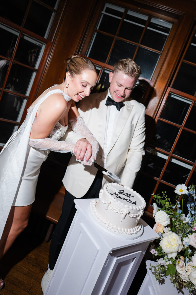 Wedding cake by Crumb Coat Cakes displayed at garden party reception in East Aurora NY.