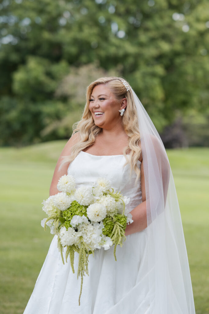 Bride holding green and white hydrangea bouquet