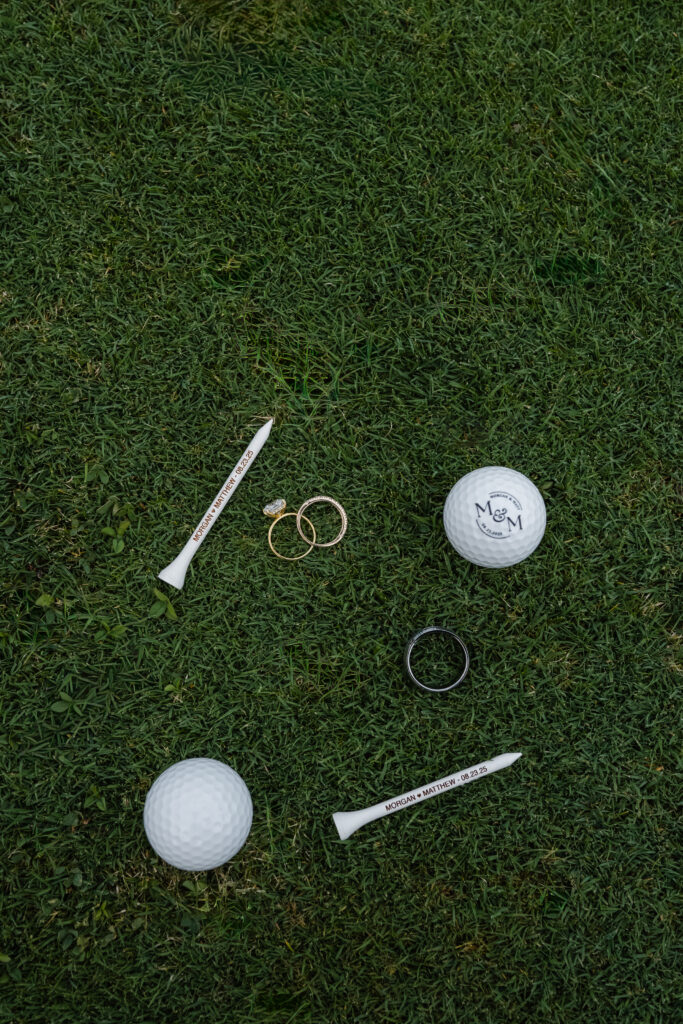 Wedding rings styled on golf ball detail