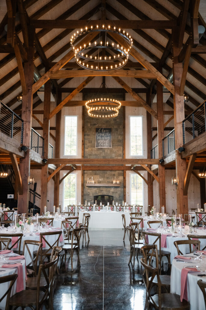 Reception details with mauve, white, and gold décor at Notting Hill Farm within timber frame venue
