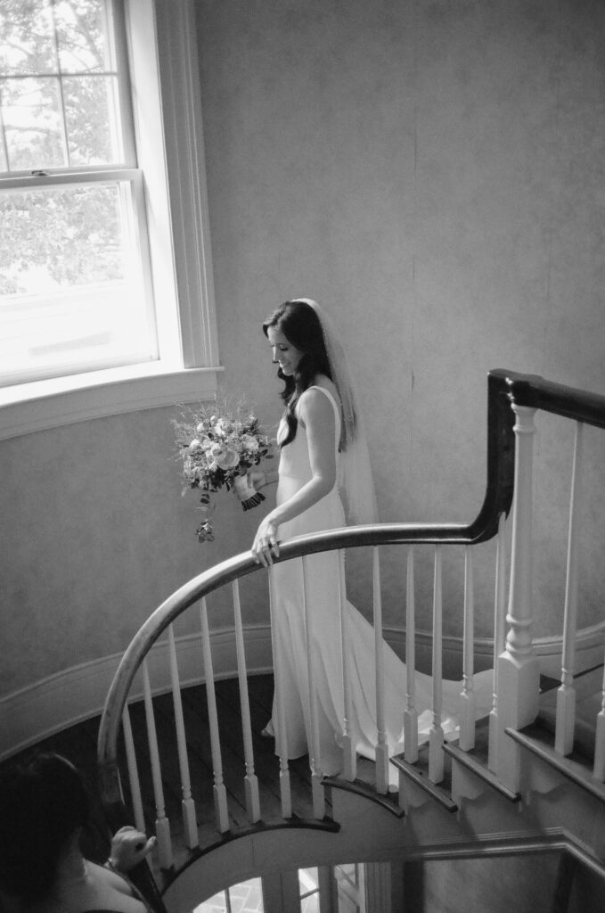 bride cascading down staircase at the seneca ridge geneva ny