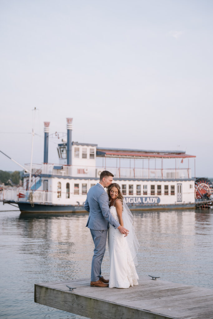 bride and groom portraits on canandaigua lake dock at sunset