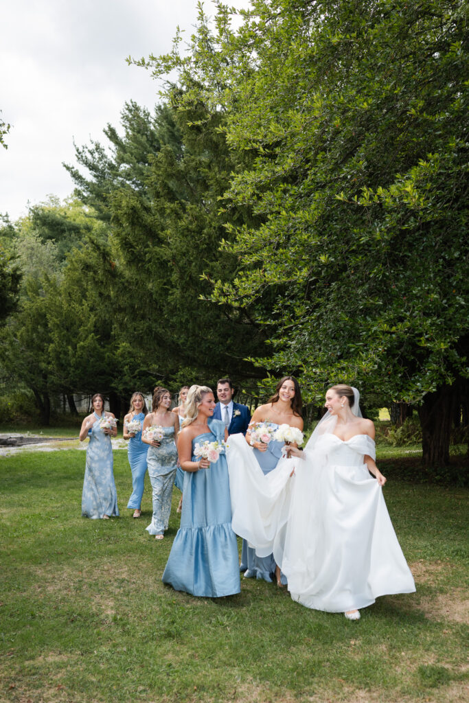 bridesmaids and bride on wedding day walking to reception area to check out details before the ceremony