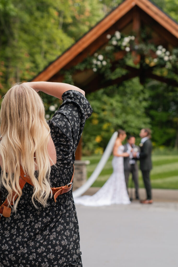 photographer taking a photo during ceremony of bride and groom