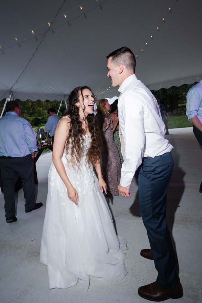 Bride and groom laughing together on the dance floor at Hillcrest Estate