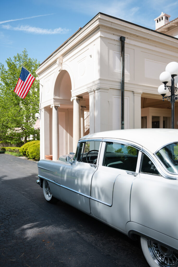 classic car for bride and groom portraits during golden hour